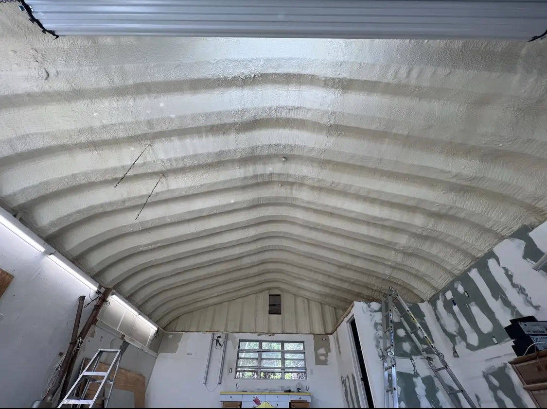 Spray polyurethane foam applied to the underside of a metal roof deck in Elba